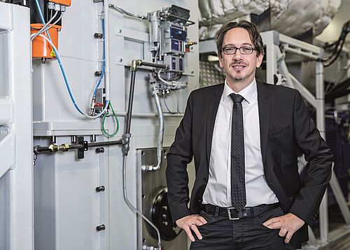 Motorenforscher Prof. Bert Buchholz vor einem der Einzylindermotoren am Forschungsstandort Rostock. (Foto: Universität Rostock/Julia Tetzke).