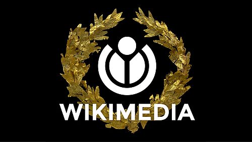 Copyright/Quelle: Jebulon, Golden laurel wreath T HL 04 Kerameikos Athens, WMDE logo added, CC0 1.08 (Wikimedia)